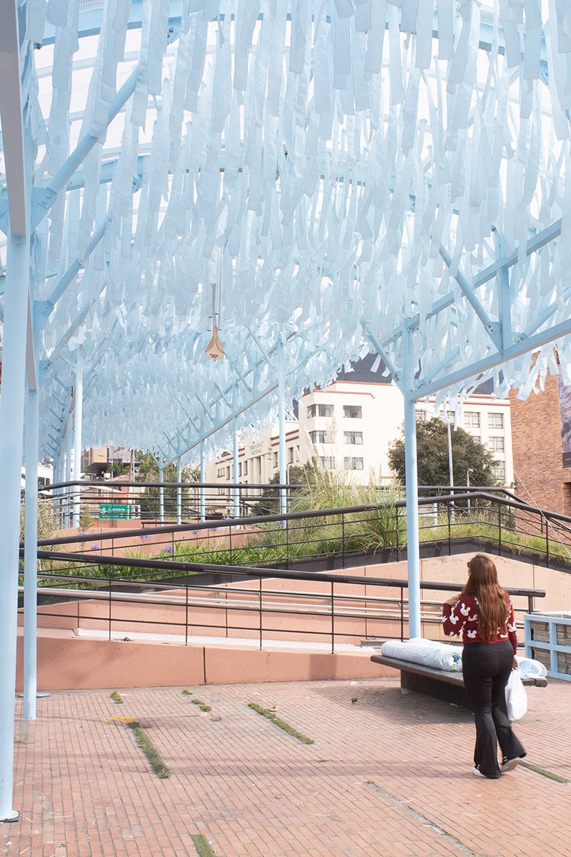 blue fabric fragments dance with the wind on modular cultural pavilion in colombia